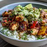 Sheet Pan Chicken Tinga Bowl featuring smoky chipotle chicken and roasted bell peppers piled over fluffy white rice.