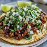 Hearty vegetarian Black-Eyed Pea Tacos served with salsa on a rustic table, perfect for a quick dinner.