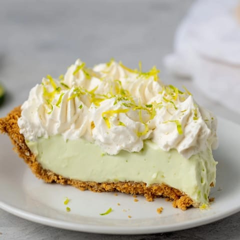 This Key Lime Pie features a golden graham cracker crust with a tart and sweet filling.