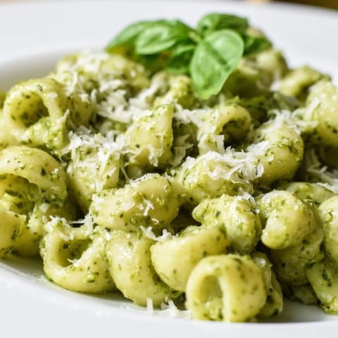 Freshly cooked macaroni tossed in a creamy avocado pesto sauce with basil, garlic, and Parmesan for a vibrant main dish.  